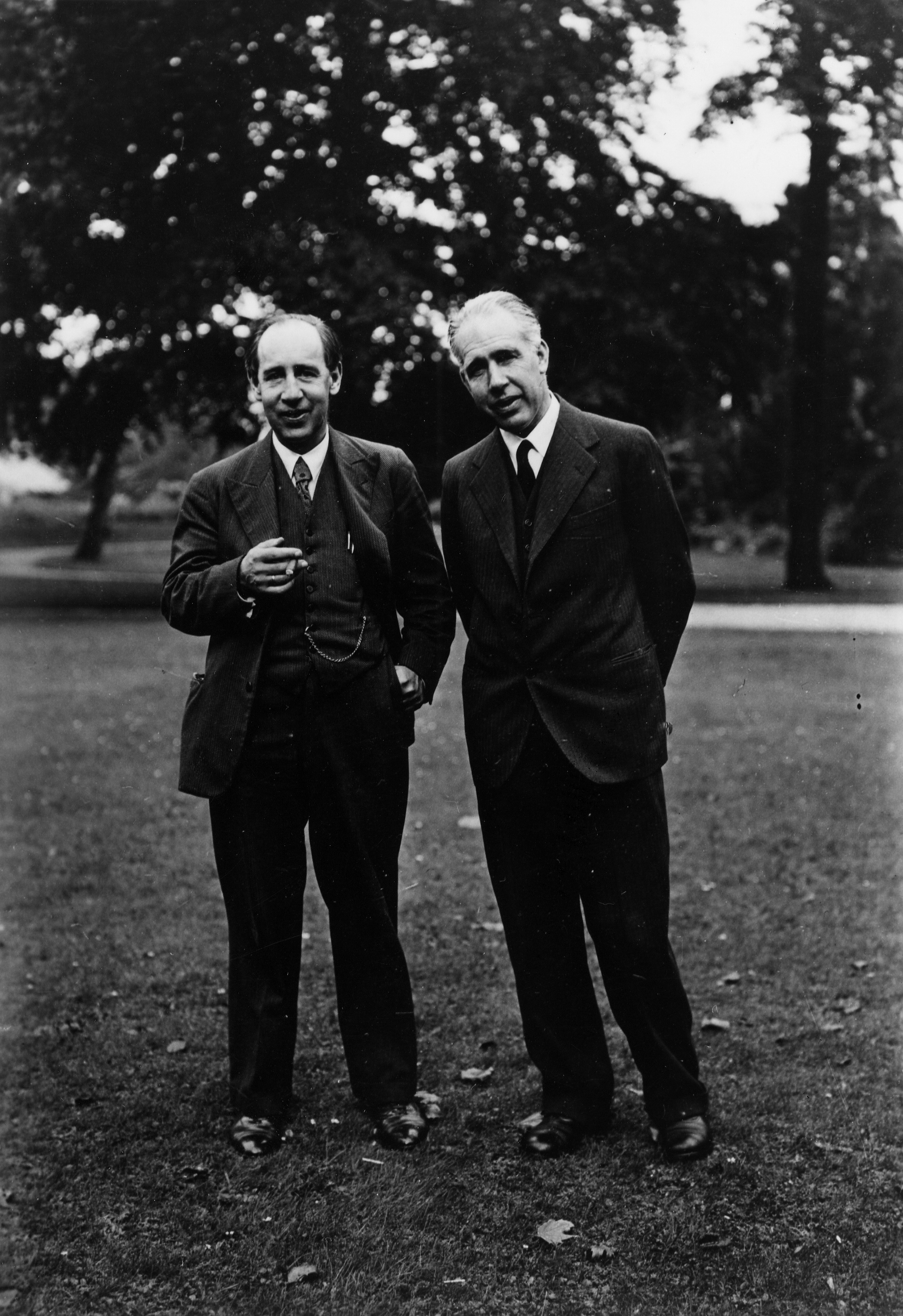 Two men standing together outdoors.