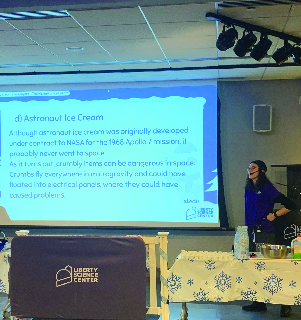 A person wearing a headset does a science demonstration.