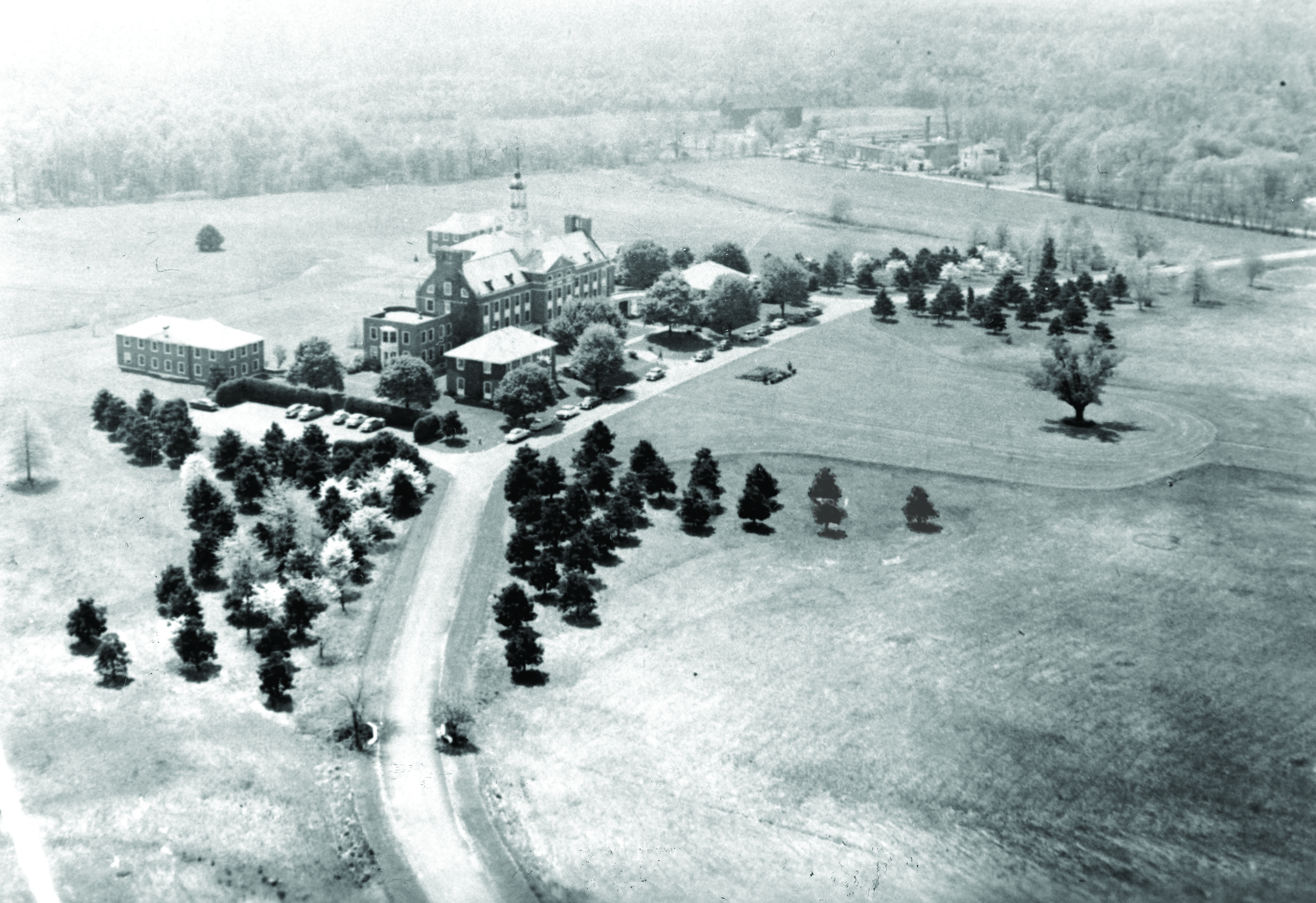 Aerial photo of a campus with buildings and trees.