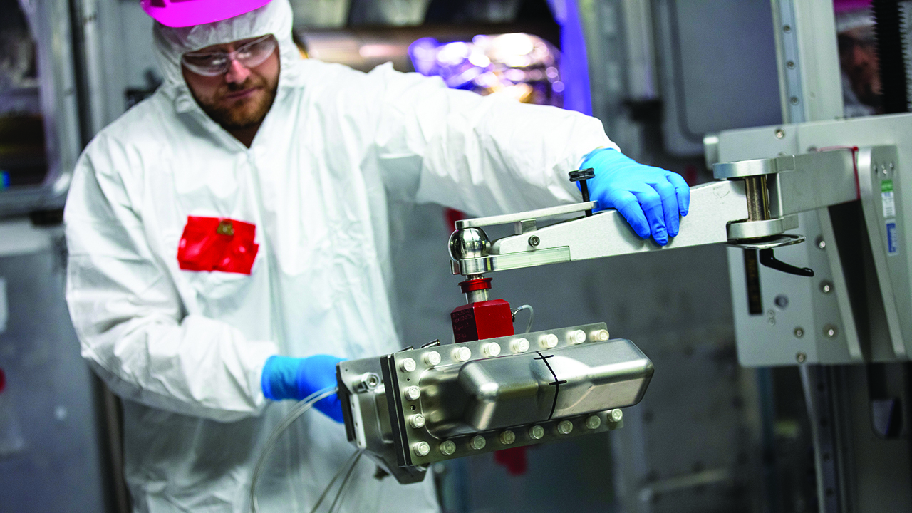 A technician analyzes a metal case