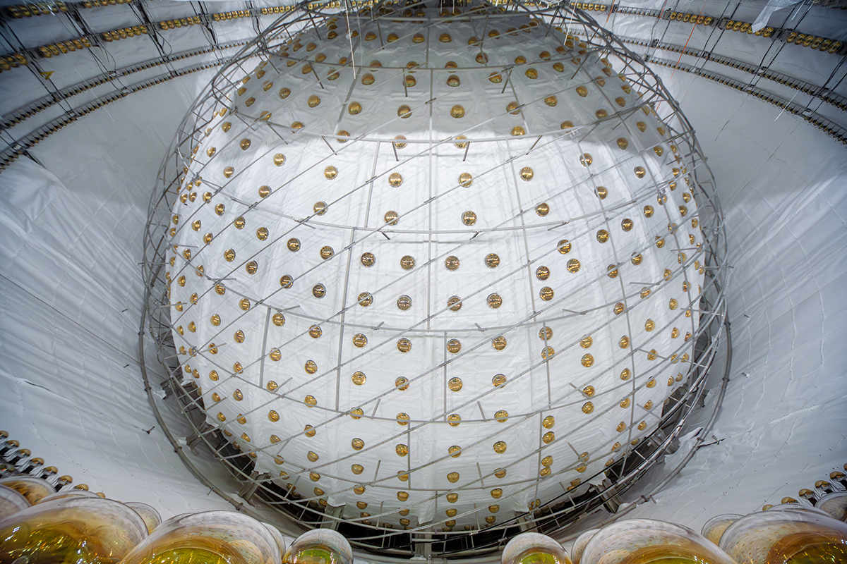 A large sphere incased in synthetic material surrounded by photomultiplier tubes.