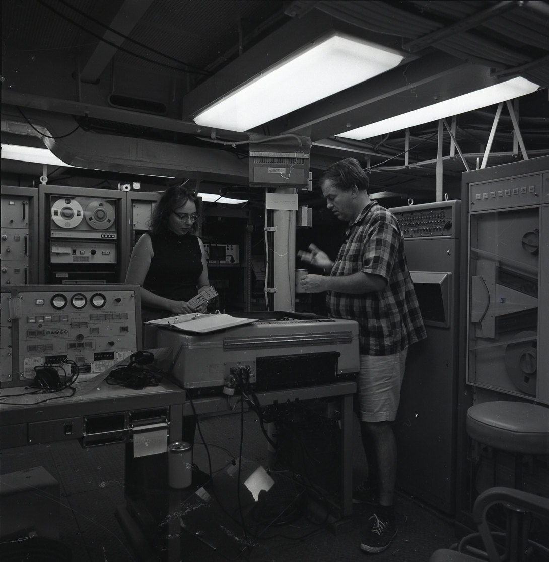 Bruce Heezen and Marie Tharp working watching the seismic plotter print