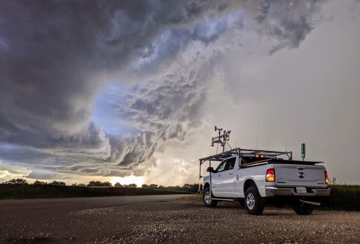 A NOAA researcher prepares to launch balloons into the core of a storm.