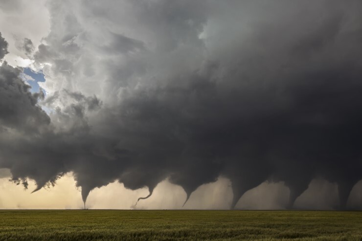 A composite of eight photos depicting the formation of a tornado.
