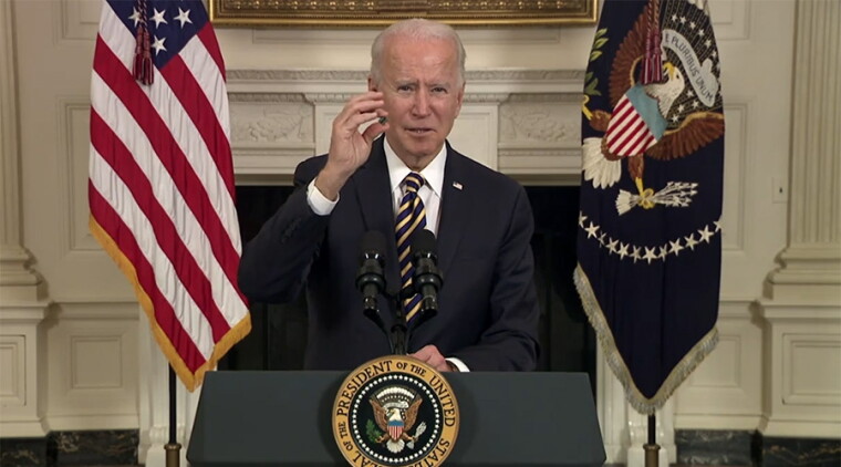 President Biden holds up a computer chip prior to ordering a supply chain review for semiconductors and other critical products.