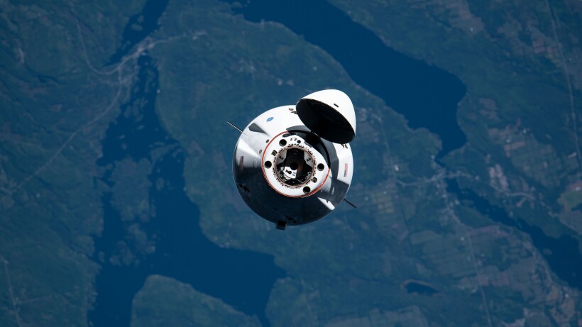 A SpaceX Cargo Dragon vehicle seen head-on as it prepares to dock at the ISS.