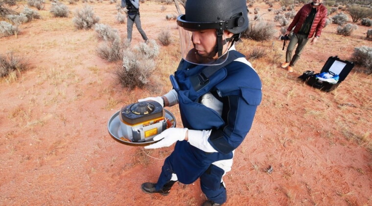 A collection team from the Japanese Aerospace Exploration Agency retrieves the asteroid sample from the Hayabusa2 mission after it landed in the Australian desert over the weekend.