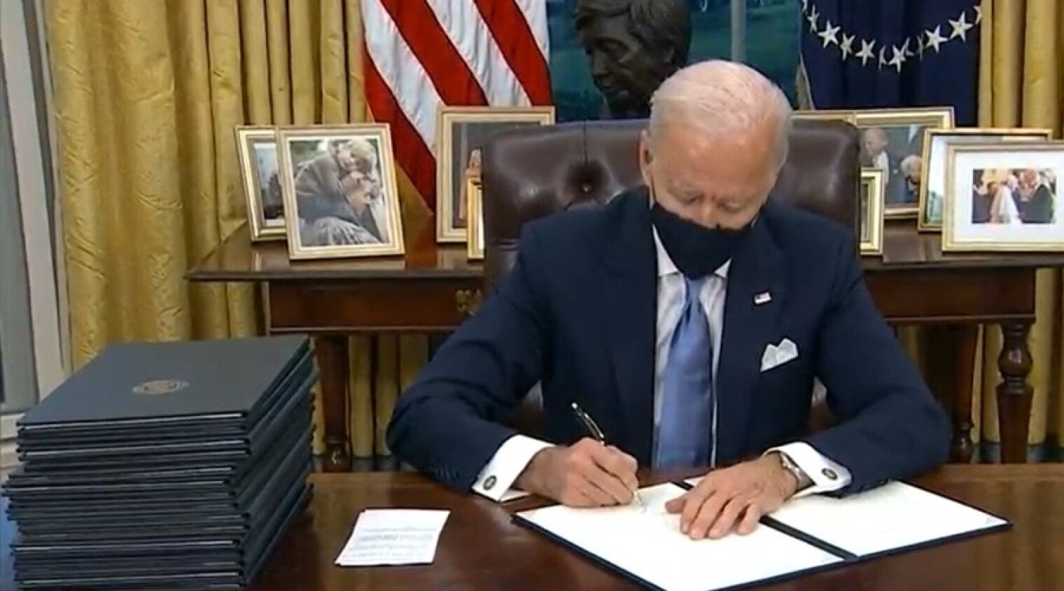 President Biden signing a series of executive orders on Jan. 20.