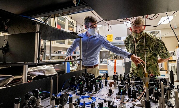 Chief of Naval Research Rear Adm. Lorin Selby, right, views an atom interferometer at the Naval Research Laboratory. (Image credit - Jonathan Steffen / U.S. Navy)