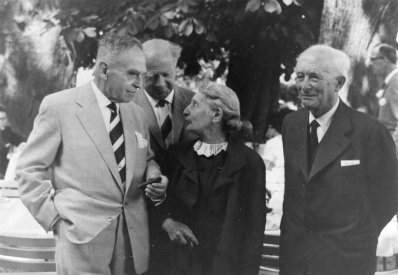 A group of people standing outside.