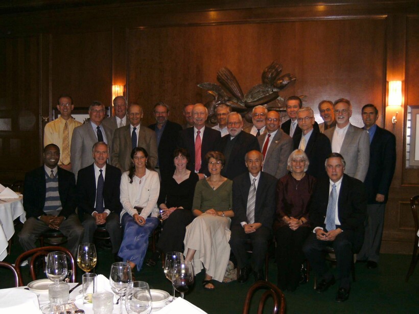 Group of people seated indoors.