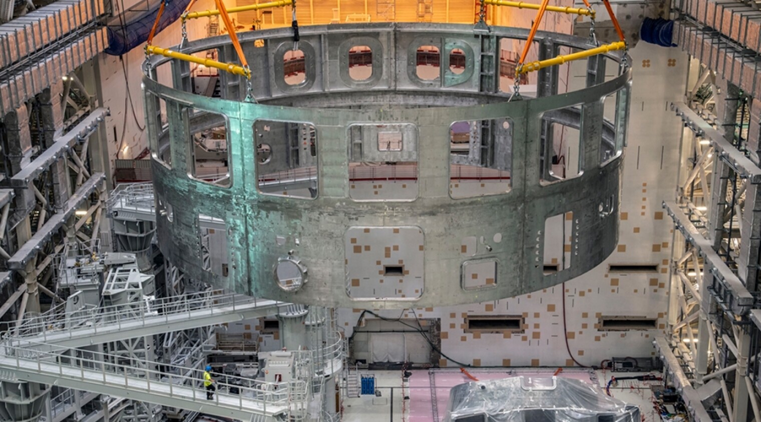 The U.S. is contributing 9% of the construction costs of the ITER fusion energy facility in France. Pictured here is a section of the facility’s cryostat built by India being lowered into place earlier this month. 