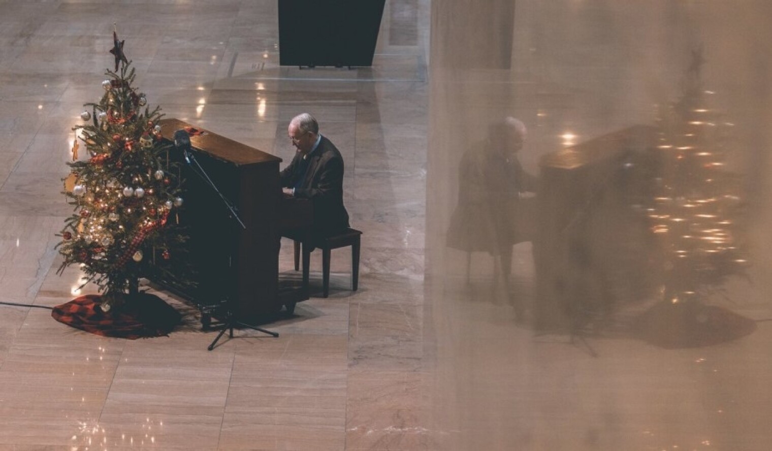 Retiring Sen. Lamar Alexander (R-TN) plays Christmas carols in the atrium of the Hart Senate Office Building on Dec. 16.