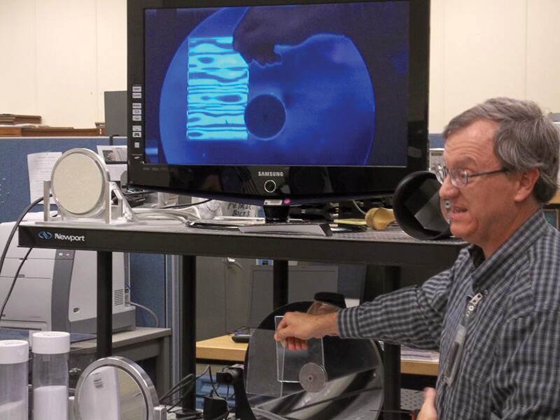 NASA's Bob Youngquist demonstrates a device for detecting leaks. Photo by Michael Harrington