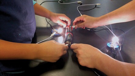 Elementary school students build circuits and light bulbs during an afterschool program organized by Guilford College's SPS chapter. Photos courtesy of Steven Shapiro.