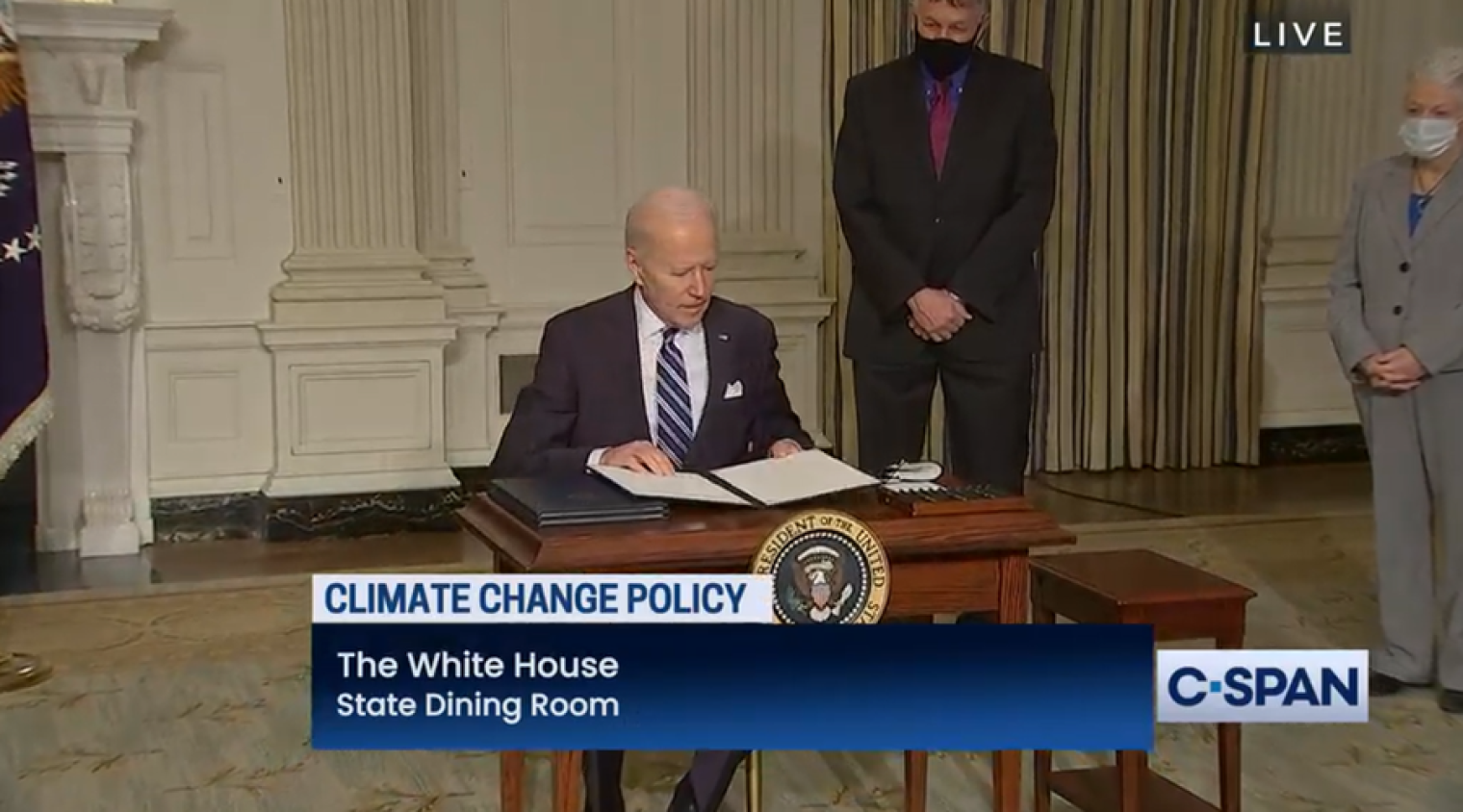 President Biden signs executive orders on climate change and scientific integrity. Behind Biden are National Climate Advisor Gina McCarthy, right, and his science advisor, Eric Lander.